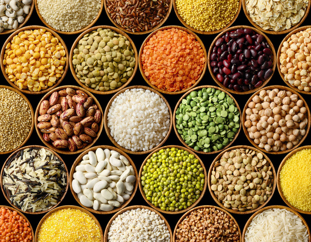 Various colorful legumes and cereals on black background - Photo, Image