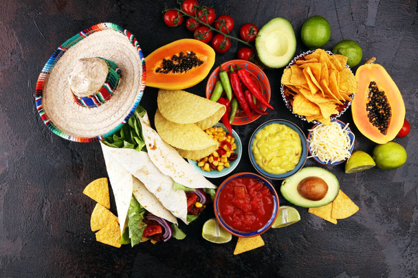 Mexican food, including tacos, guacamole, nachos and pepper on r - Photo, Image
