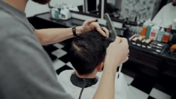Haircut and beard haircut in barbershop.  - Кадры, видео