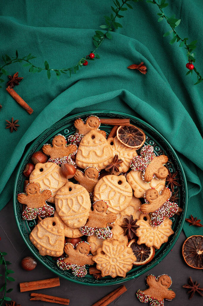 Tasty homemade Christmas cookies in the green plate. - Photo, image