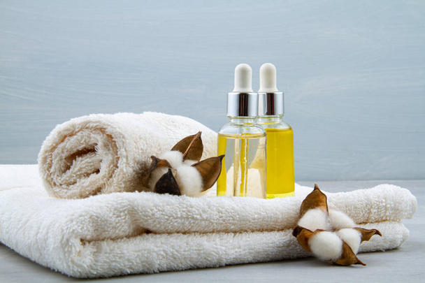 Spa and wellness composition with serum, towels and beauty products. - Photo, image