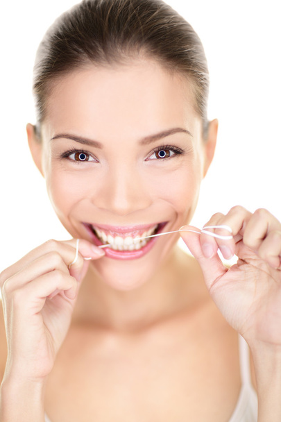 Woman flossing teeth smiling using dental flush - Фото, зображення