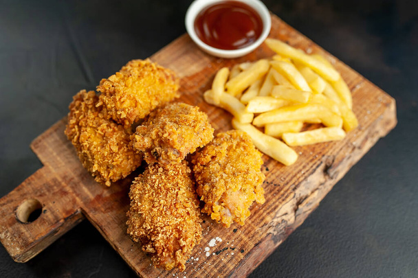 fried fries and cookies on wooden table - Photo, Image