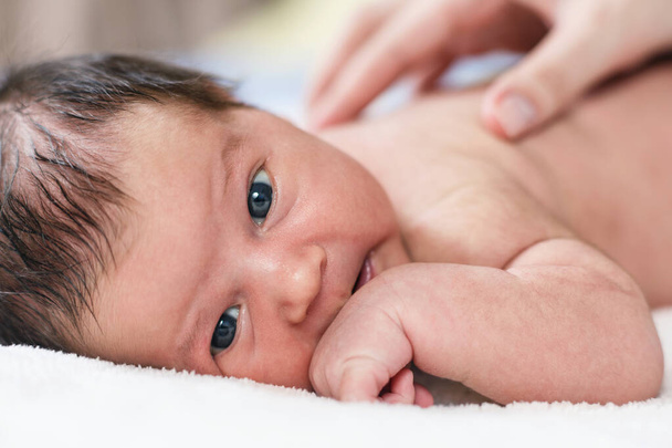 Cute newborn baby looking at the camera. - Fotoğraf, Görsel