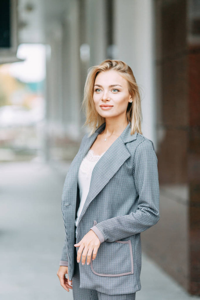 Business style, the situation in the bright office and outside. Business portrait of a beautiful girl on the street.  - Foto, afbeelding