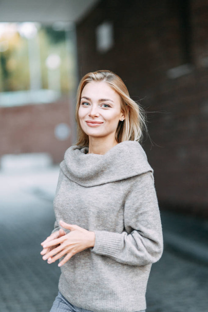 Woman in jacket emotional portrait. Beautiful smiling girl in town.  - Valokuva, kuva