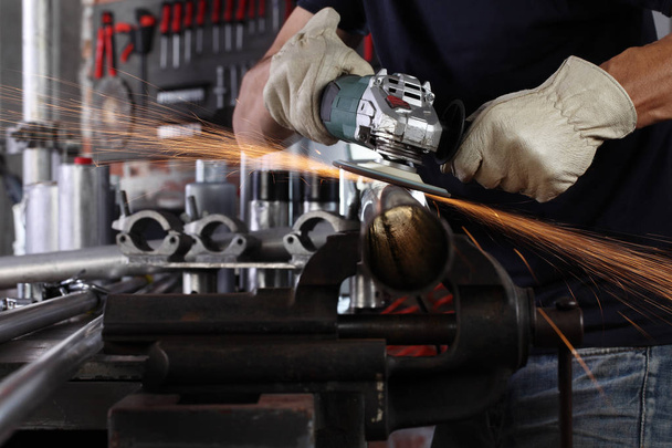 hands man work in home workshop garage with angle grinder, goggl - Photo, Image