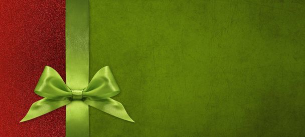 tarjeta de regalo de Navidad con lazo de cinta verde en respaldo verde y rojo
 - Foto, imagen