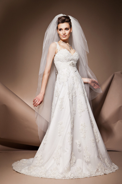 The beautiful young woman in a wedding dress - Фото, зображення