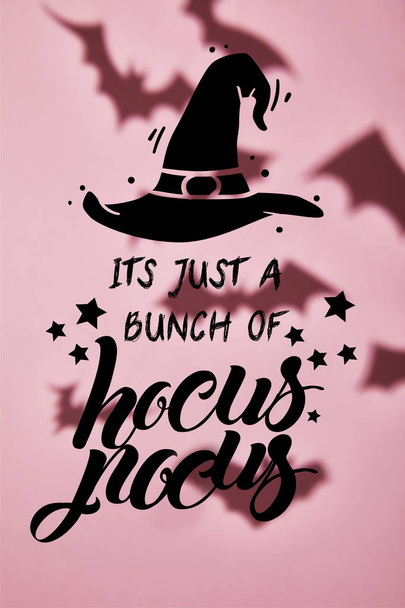 shadow of flying bats on pink background with its just a bunch of hocus pocus illustration - Photo, Image