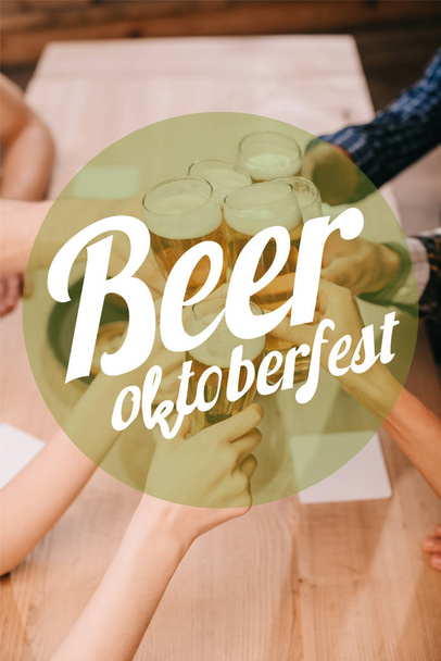 揚げソーセージ、玉ねぎリング、フライドポテト、プレッツェル、マグカップの上からの眺めビールとパブの木製テーブルでビールオクトーバーフェストのイラスト - 写真・画像