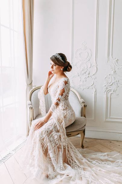 European-style wedding at the hotel. Bride in a white dress in the interior Studio.  - Fotó, kép