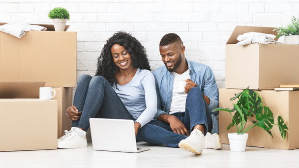 Happy man and woman purchasing furniture online for new apartment - Photo, Image