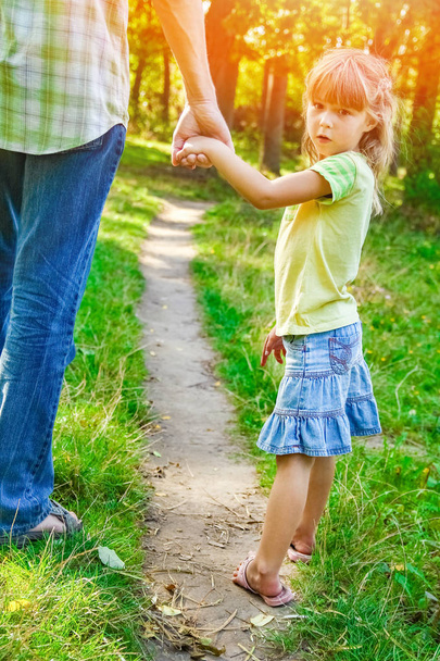 the parent holding the child's hand with a happy background - Foto, Bild