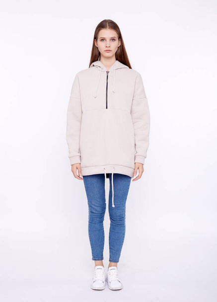 Young girl wearing blank and oversize long hoody. White background - Fotó, kép