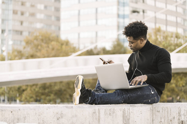 black student with computer and phone at city - Foto, Imagen