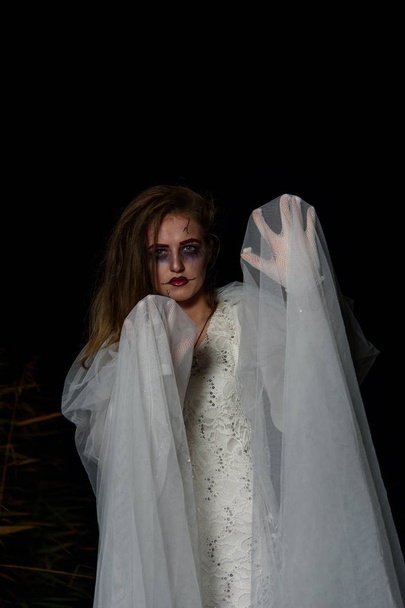 Creepy dead bride at night in a swamp. Halloween scene - Fotografie, Obrázek