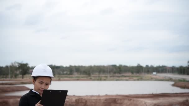 Engineer woman working at building project site  - Video