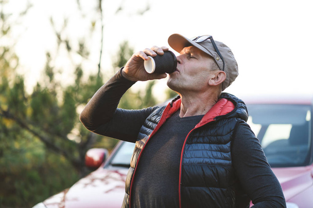 ein alter Mann trinkt ein Heißgetränk - Foto, Bild