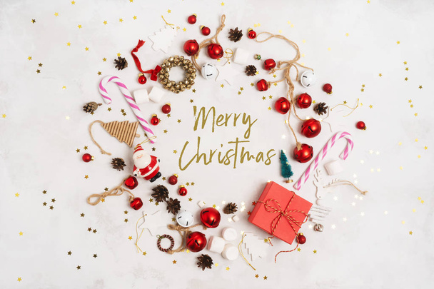 Merry Christmas and New Year text for greeting card, round frame, banner.  Happy Holidays Creative layout. Christmas props tree toys on white background top view. Winter holiday xmas theme. - Fotografie, Obrázek