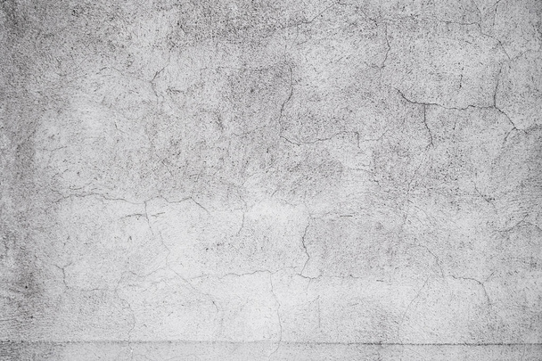 Cracked concrete grey wall covered with gray cement texture as background can be used in design. Dirty concrete texture with cracks and holes. - Photo, Image
