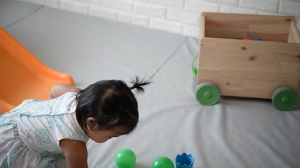 cute little Asian girl playing in child room - Záběry, video