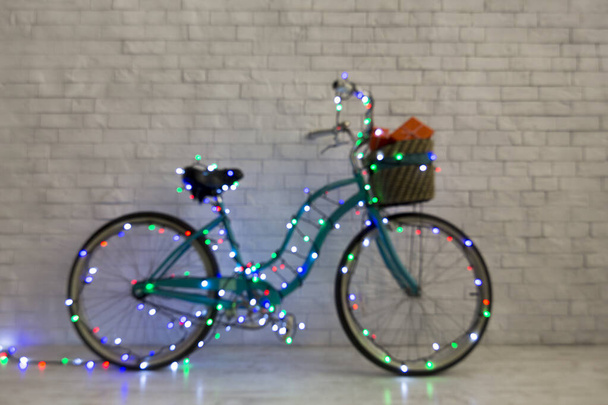Santas bicycle with presents and Christmas lights - Fotó, kép