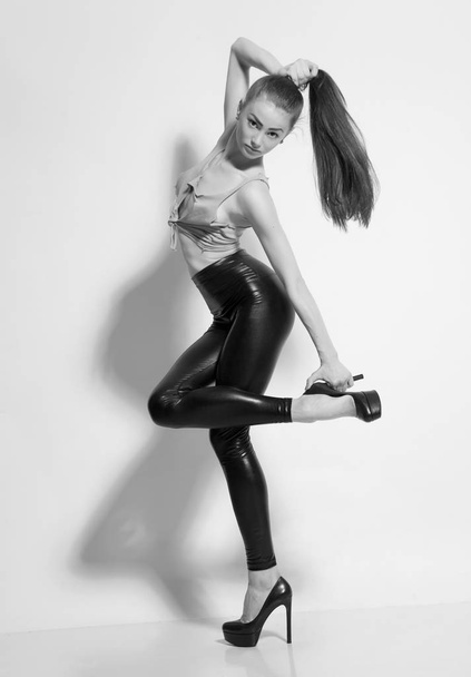 Girl posing in leather leggings and heels - Fotografie, Obrázek