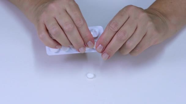 Fingers pulling tablets out of the package - Filmmaterial, Video