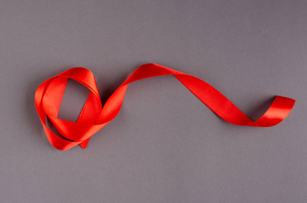 Red ribbon composition on dark background, New Year and Christmas holiday. - Foto, imagen