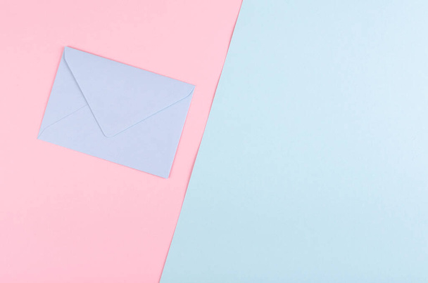Blue paper envelope composition on pink background. - Fotoğraf, Görsel