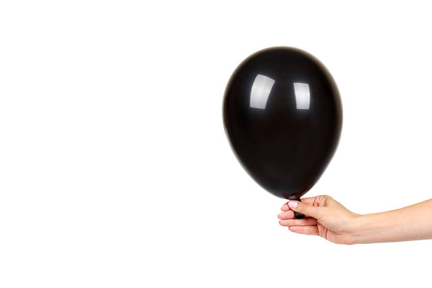 Hand with black inflateble balloon, party event decoration, glossy ball. - Φωτογραφία, εικόνα