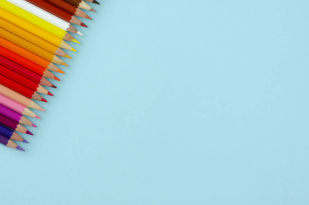 Colored pencils composition on blue background. Flat lay. - Fotografie, Obrázek