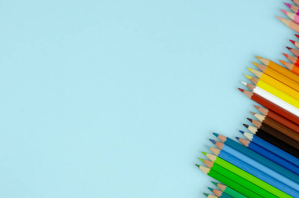 Colored pencils composition on blue background. Flat lay. - Fotoğraf, Görsel