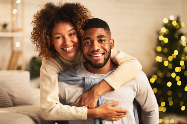 Christmas eve. Loving couple embracing and smiling to camera - Foto, Imagen