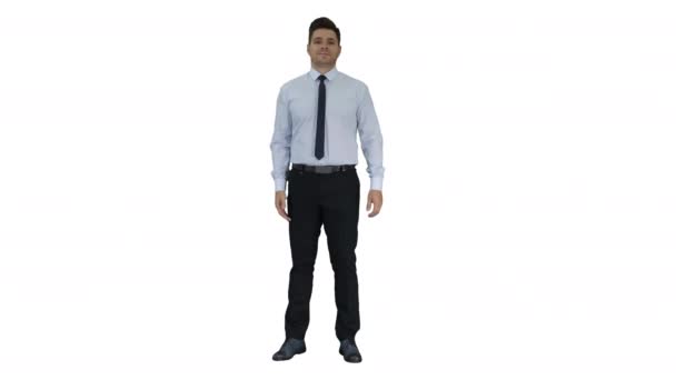 Young businessman walking in frame and talking to camera presenting something on white background. - Footage, Video