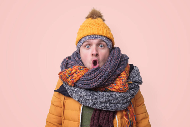 Handsome caucasian funny man in several hats and scarfs. - Photo, Image