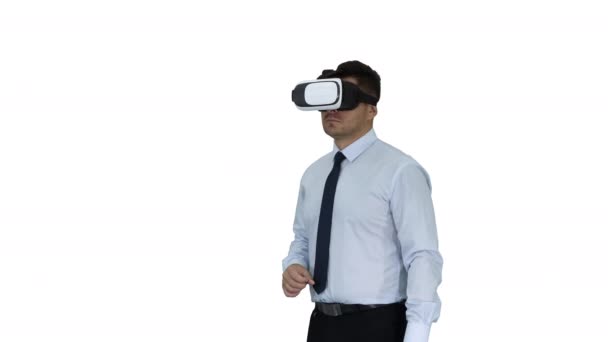 Businessman in VR glasses and interacting with virtual reality objects on white background. - Кадри, відео