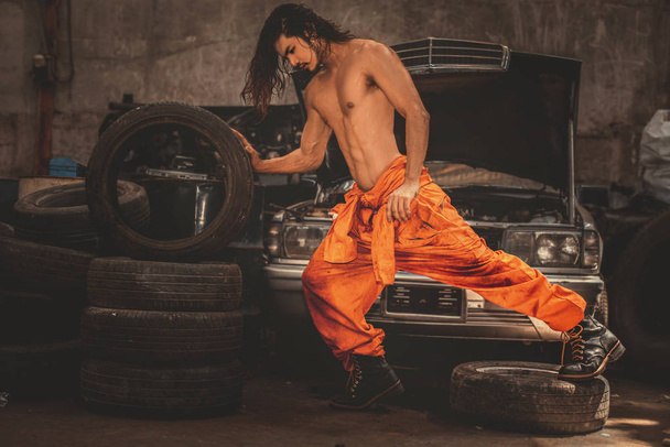 Fashion portrait mechanic man in the garage  - 写真・画像