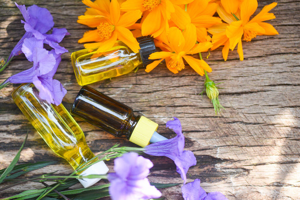 Aromatherapy herbal oil bottles aroma with yellow wildflowers on - Photo, Image
