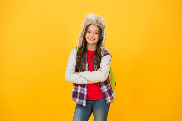 Winter events at school. Eskimo style. Winter entertainment and activities. Child schoolgirl long hair soft hat enjoy season. Winter season concept. Kid girl wear hat with ear flaps. Winter vacations - Photo, Image