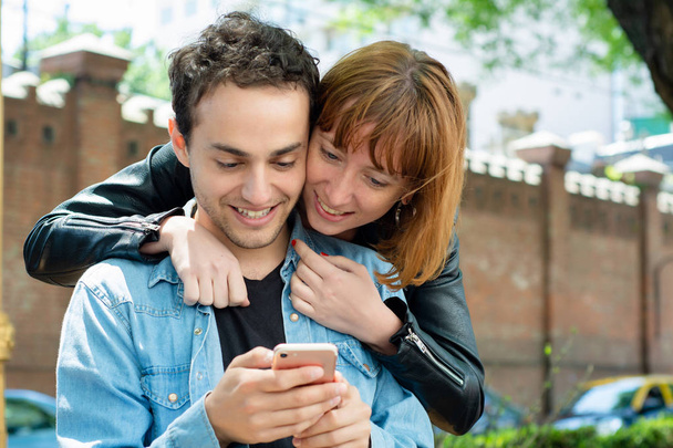 Young couple using application on smartphone - Foto, afbeelding