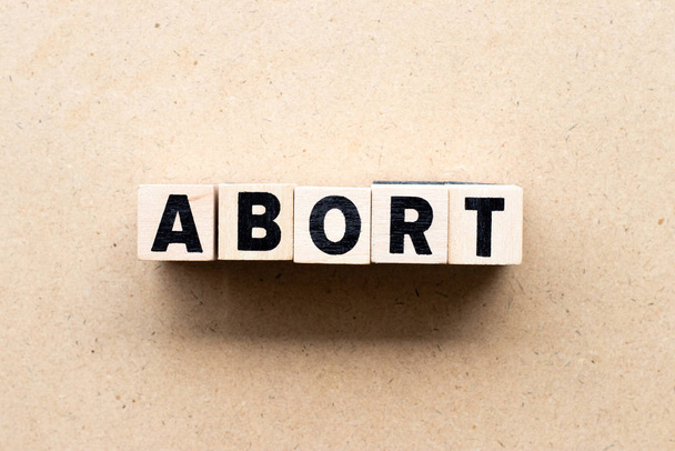 Letter block in word abort on wood background - Zdjęcie, obraz
