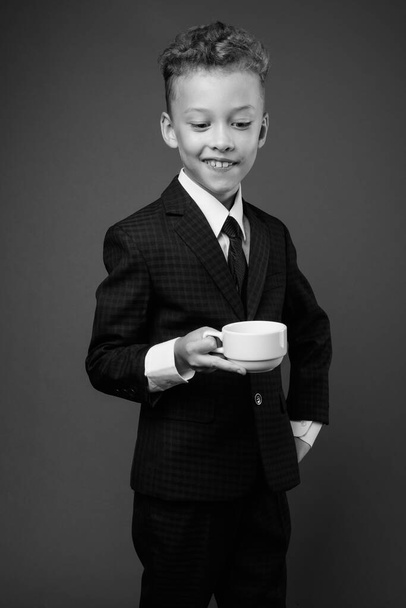 Young boy as businessman wearing suit in black and white - Foto, imagen