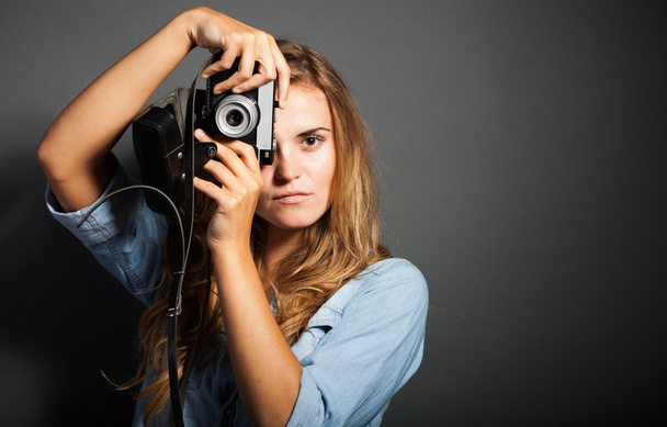 Photographer in jeans jacket taking pictures with old camera - Photo, Image