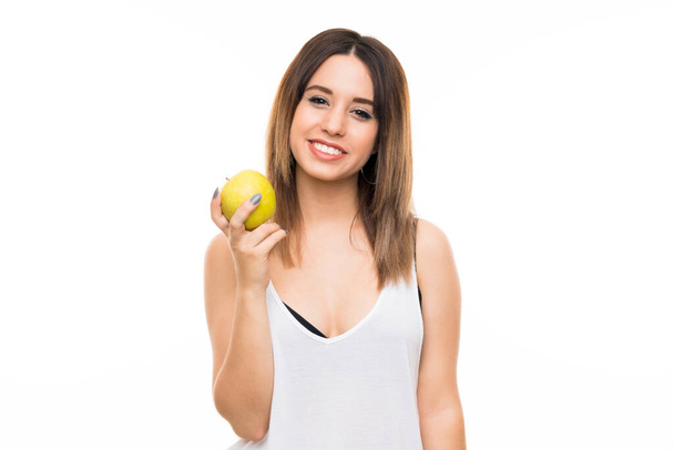Молодая женщина на изолированном белом фоне с яблоком - Фото, изображение