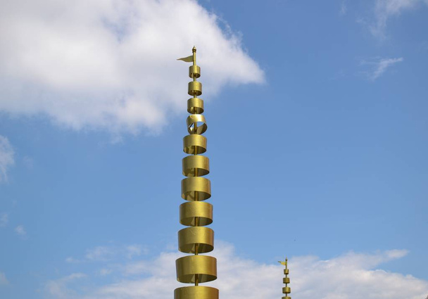 Золотой многоуровневый зонтик, украшенный в храме
  - Фото, изображение