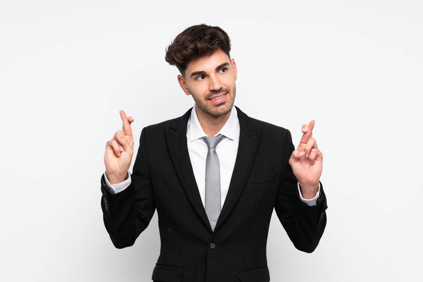 junger Geschäftsmann vor isoliertem weißen Hintergrund mit Daumendrücken - Foto, Bild