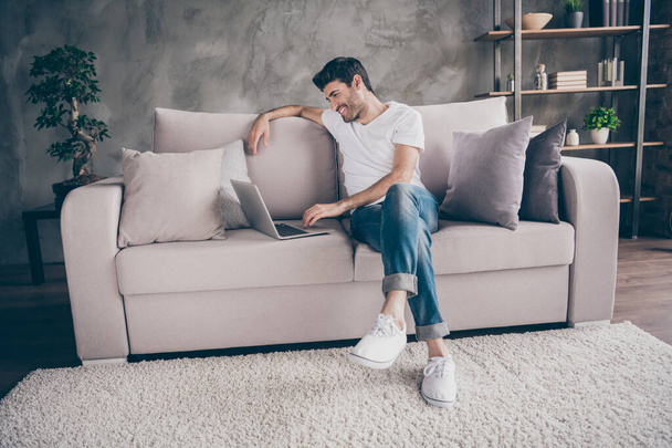 I miss you so much. Profile photo of mixed race guy sitting cozy sofa holding notebook speaking skype with relatives communicating wear casual outfit flat loft living room indoors - Photo, image