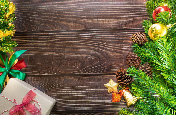Christmas fir tree, festive. Composition decorations and xmas gift boxes on dark wooden board background. Celebration for holiday concept Christmas, New Year, winter. Flat lay, top view with free space copy for text. - 写真・画像